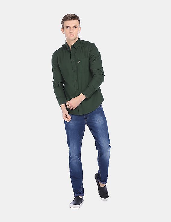 dark green shirt with dark blue jeans